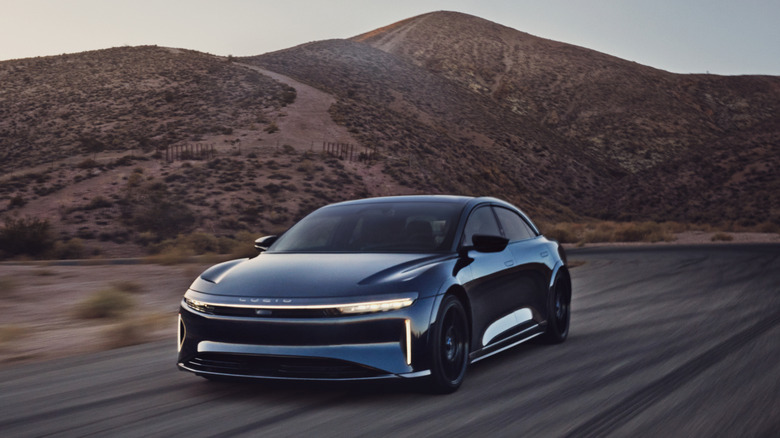 2023 Lucid Air driving at speed at Willow Springs Raceway, front-left 3/4 view