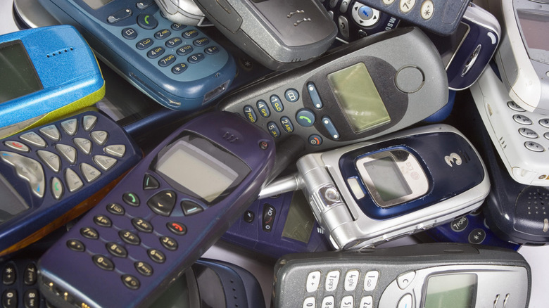 A stockpile of old mobile phones from the pre-smartphone era.