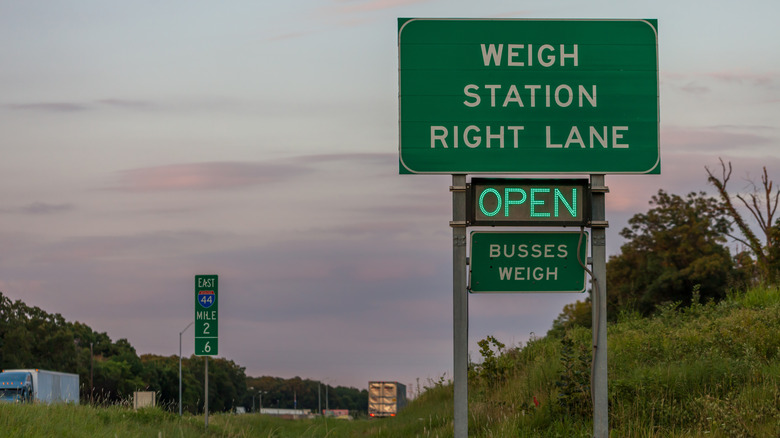 A roadside sign on Interstate 44 indicates an open weigh station in the right lane, with an additional notice stating "Busses Weigh."