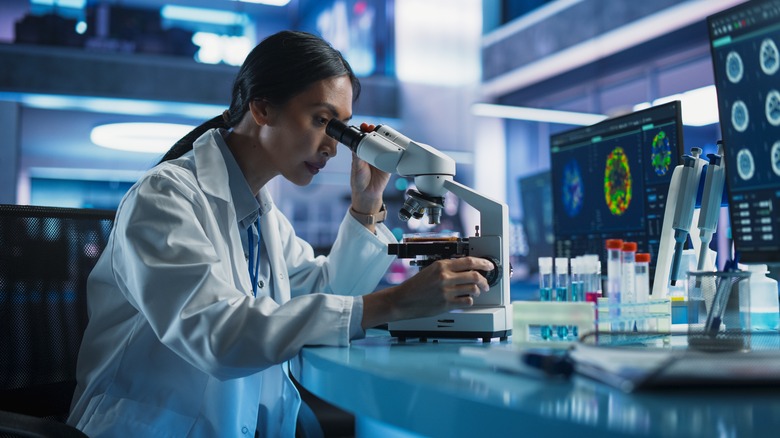 Scientist looking through a microscope