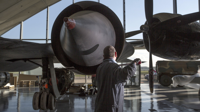 The close up of a SR-71 Blackbird's engine as it is being cleaned by a professional
