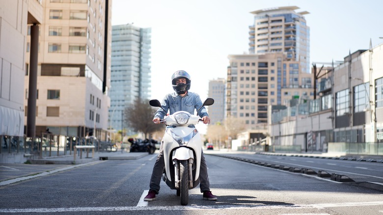 motorcyclist with helmet on road