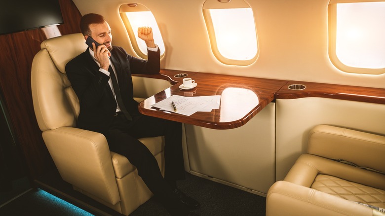 Businessman on the phone in a private jet