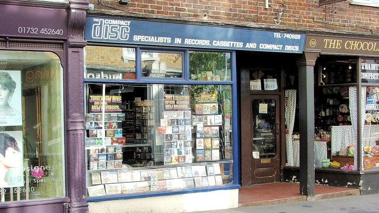 Front windows of a record shop, sign that reads "Specialists in records, cassettes, and compact discs"
