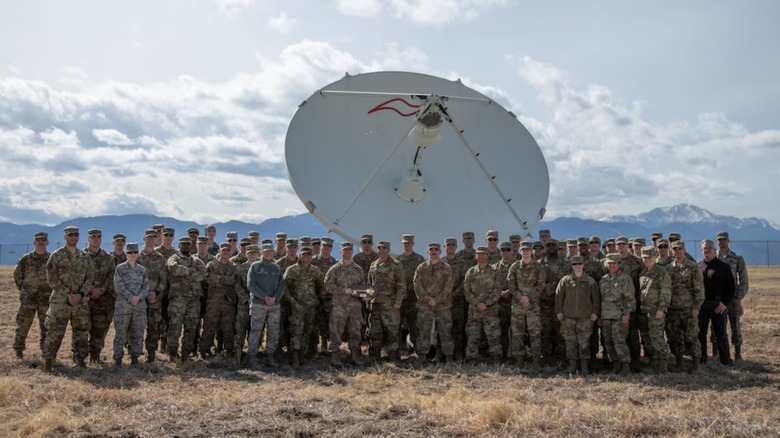 Airmen from the 4th Space Control Squadron take a picture in front of the Counter Communications System Block 10.2.