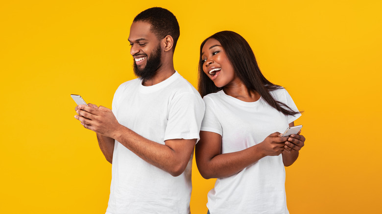 Two people on their phones