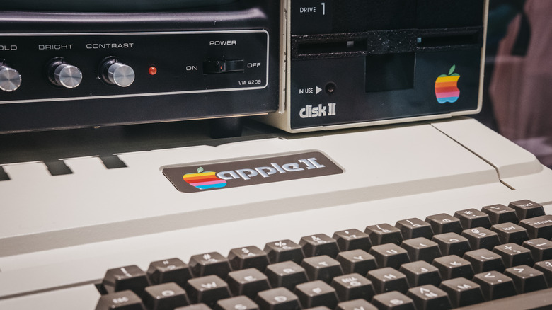 Apple II computer keyboard, floppy disk drive and monitor