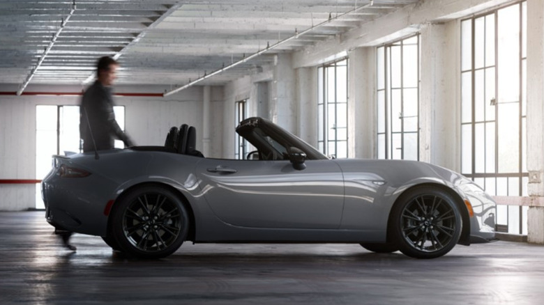 man walking up to 2026 miata in a garage