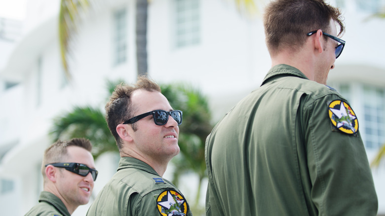 A trio of young Air Force pilots walk together on Ocean Drive in South Beach