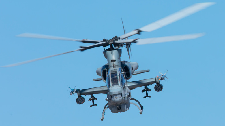 Blue gray AH-1Z helicopter flying