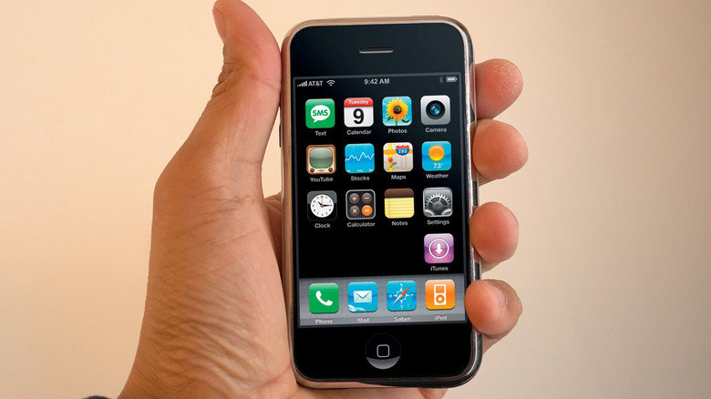 First iPhone held by left hand
