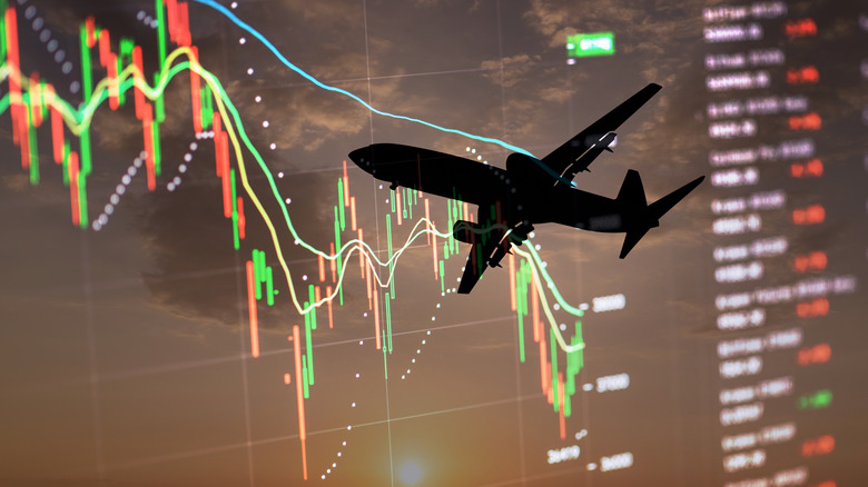 A silhouette of a passenger airplane against the backdrop of a statistical graph.