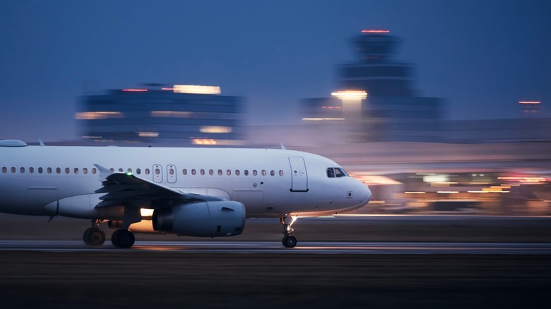 Airplane speeding down a runway
