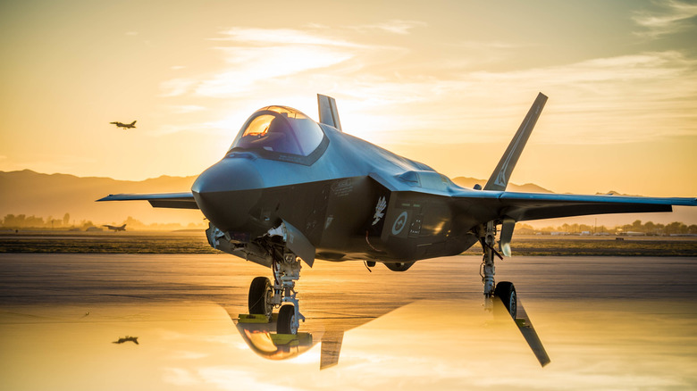 The sun sets behind an Australian F-35A Lighting II at Luke Air Force Base