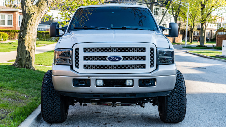 Front view of 2007 Ford F-250 heavy duty pickup truck with large tires on suburban street