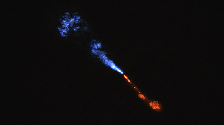 A telescopic image of jets of silicon monoxide (SiO) blowing away from the baby star HOPS-315.