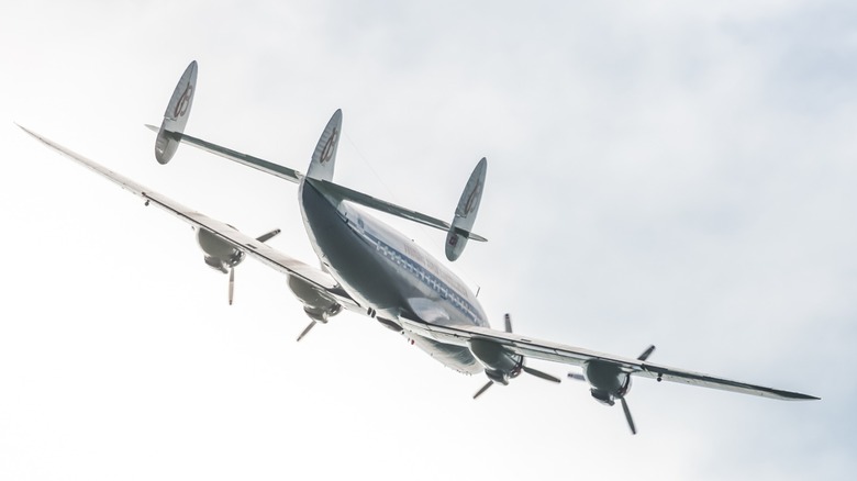 a Lockheed Constellation flying over an airshow