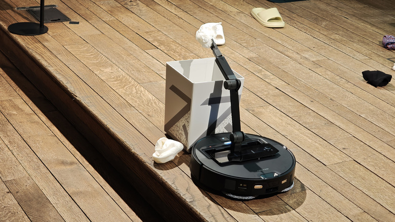 Roborock Saros Z70 depositing trash in a can