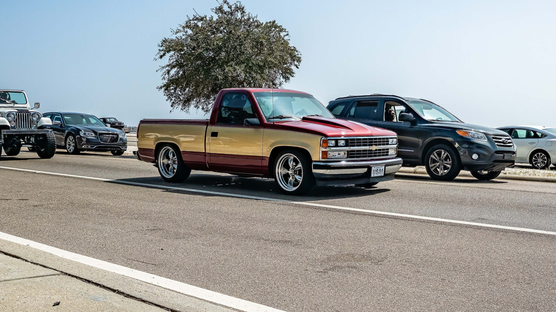 Wine and gold 1988 Chevy Silverado driving