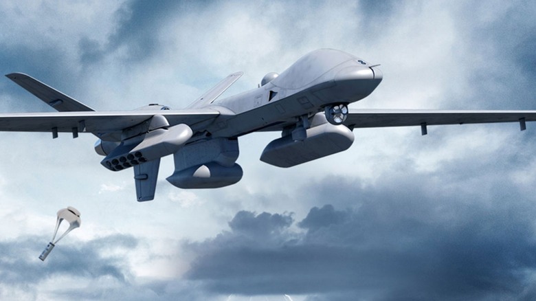 An MQ-9B SeaGuardian flying over cloudy skies after dropping a sonobuoy that falls via a parachute.