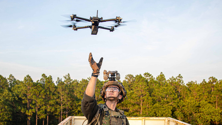 A soldier prepares to catch a drone
