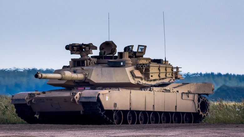 An M1 Abrams tank driving on a path.