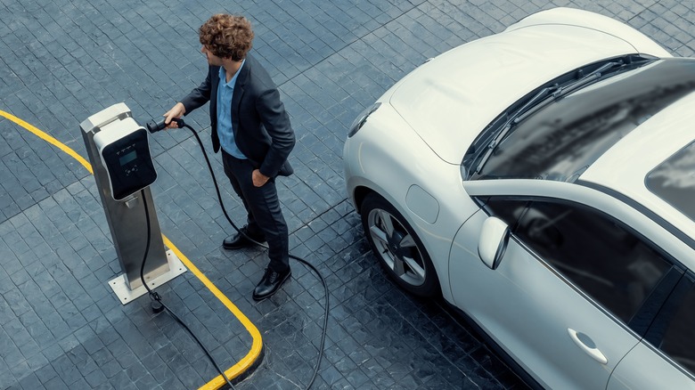 Person plugging in EV charging