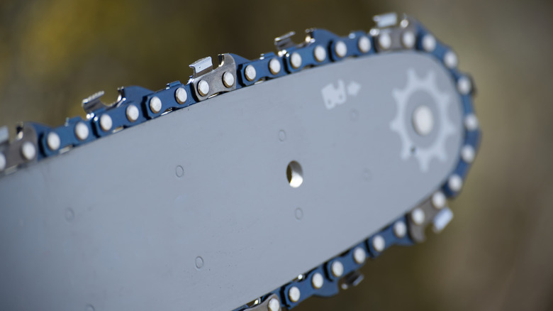A closeup of a saw chain showing the cutting teeth in detail.