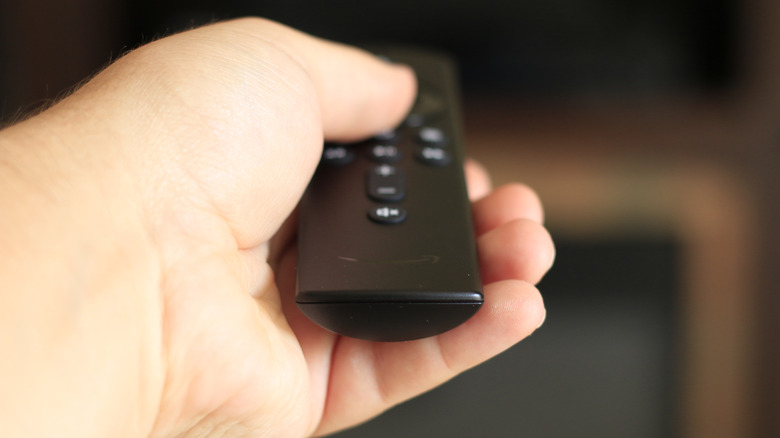 Person holding Fire TV remote