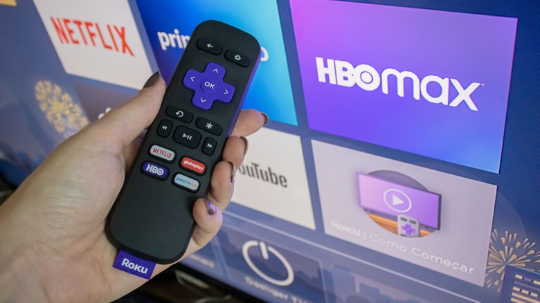 Woman holding Roku remote