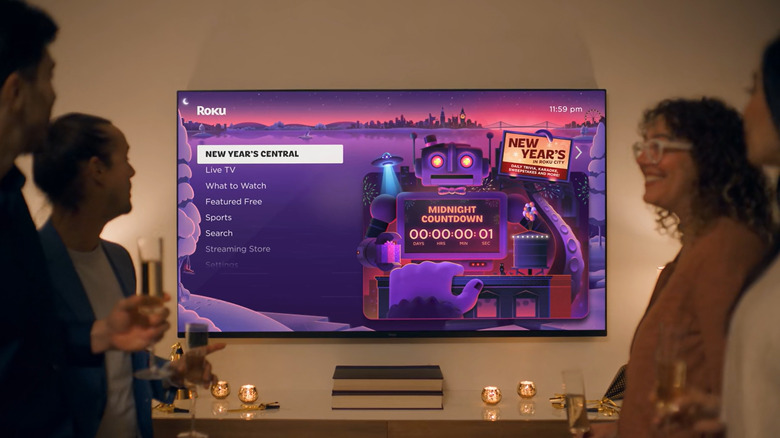 Roku TV showing New Year's Central screen with people partying in the living room