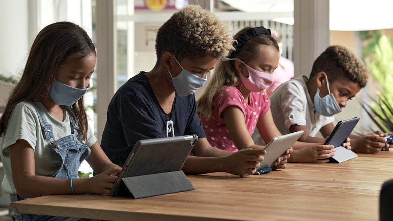 Kids looking at tablets