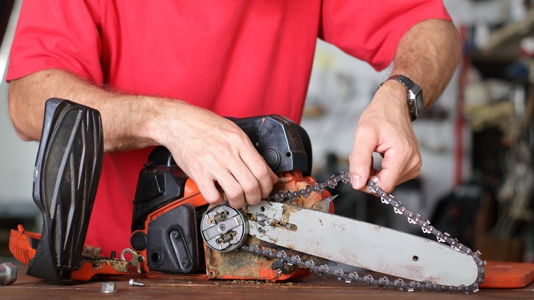 Man working on chainsaw chain