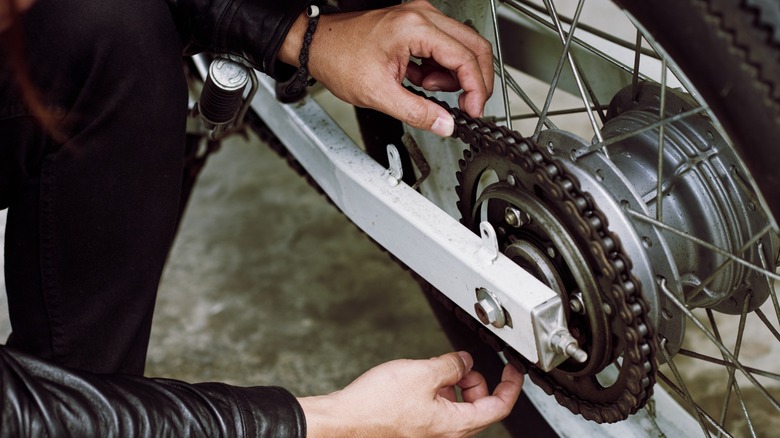 hands-on inspection of motorcycle chain