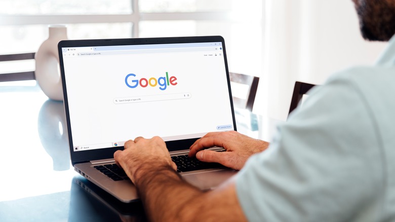 Man using a computer to search Google