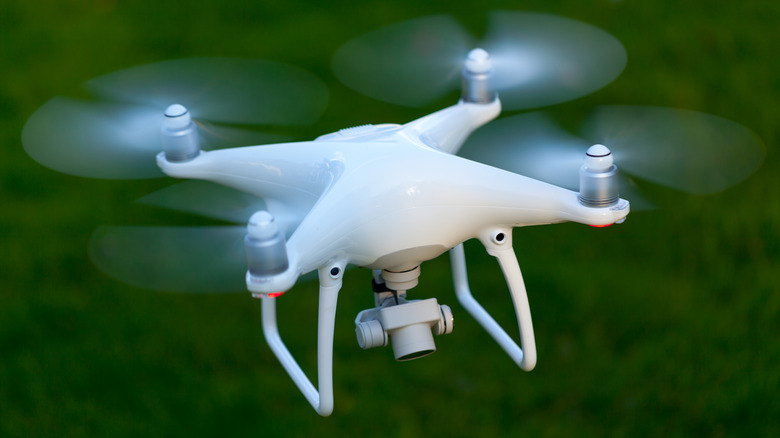 A drone flying above grass.