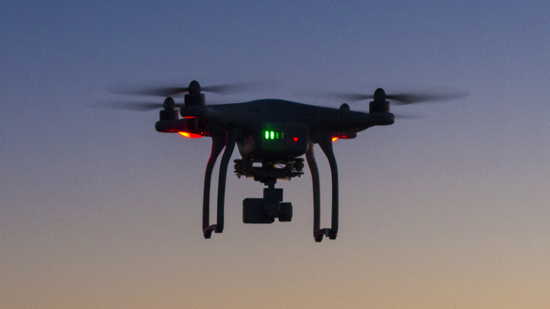 A drone flying at sunrise.