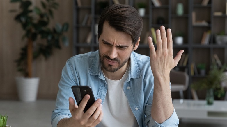 annoyed person with smartphone