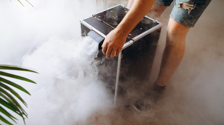 Man operating a fog machine