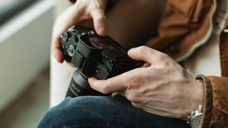 A person toggling the controls on their camera