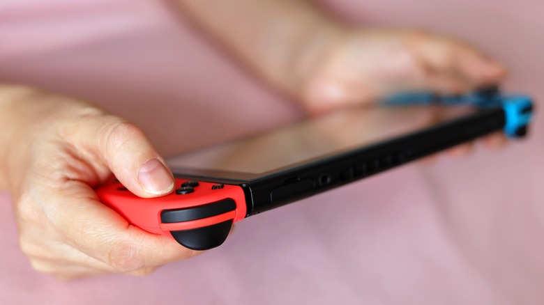 Holding a Nintendo Switch