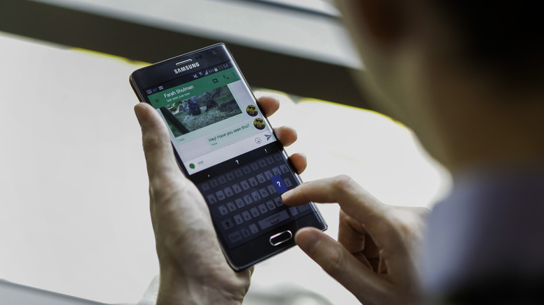 man texting on samsung phone