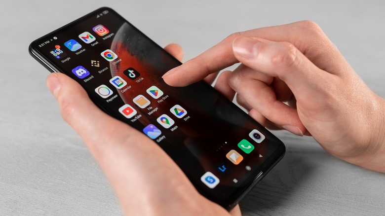 hands holding Android phone