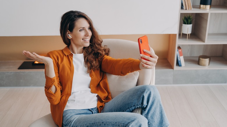 Woman with AirPods on phone
