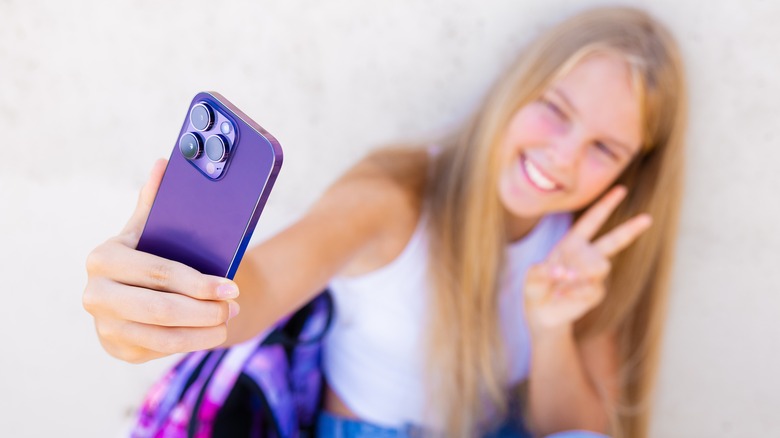 teen girl using iphone
