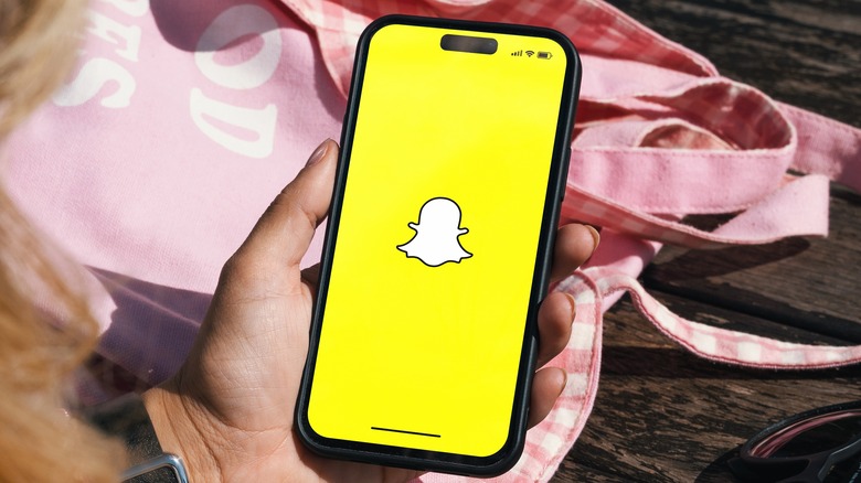 woman using snapchat on phone