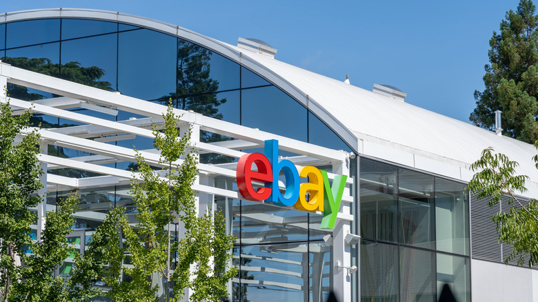 Exterior of an eBay corporate building featuring the company's color logo on a modern glass facade.