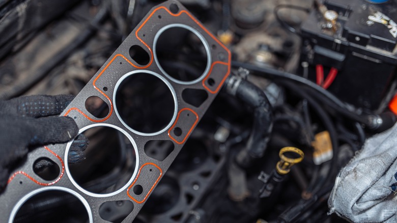 Mechanic holding new head gasket