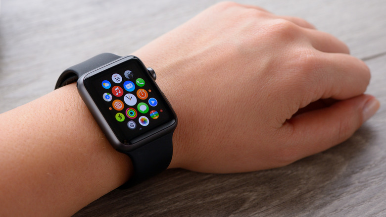 Hand wearing Apple Watch showing apps