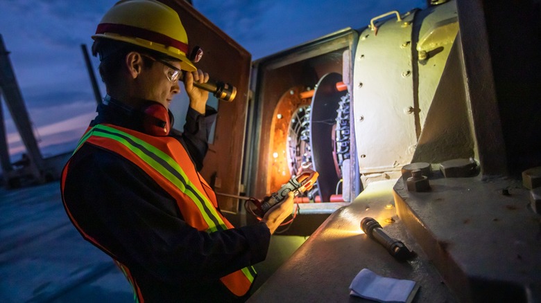 Construction worker using flashlight 